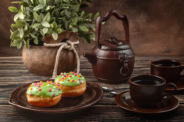 Bun, donut covered with glaze. Tutti frutti bun on a plate. Sweet pastries. Dessert. Still life. Close-up.