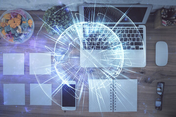 Business theme hologram drawings over computer on the desktop background. Top view. Multi exposure. Concept of international connections.