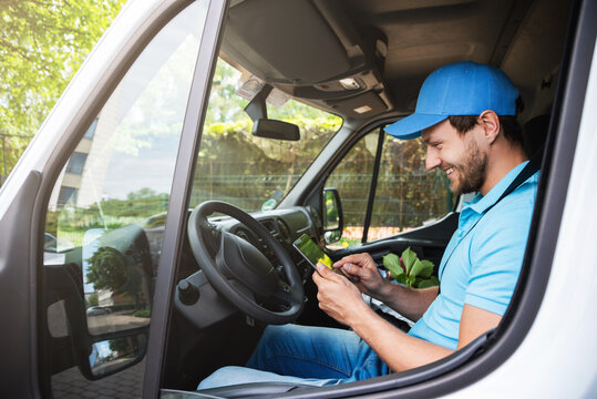 Delivery man with a tablet pc in his van