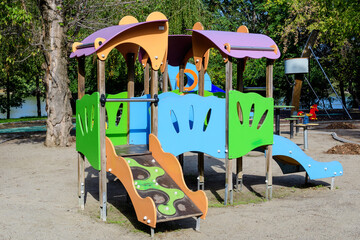 Colourful children playground with mixed plastic and metallic toys and materials in a sunny summer day in Bucharest, Romania .