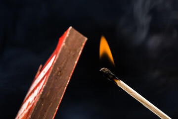 burning match  and box  on black background  - Image