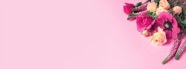 Obraz na płótnie Canvas Fresh multicolor summer flowers on the pink background, vibrant bouquet