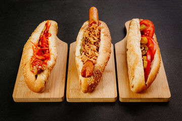 set of hot dogs on black background