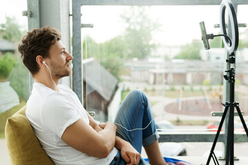 Young handsome blogger working at home