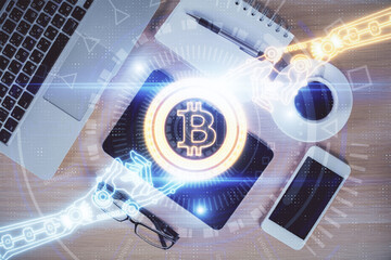 Double exposure of blockchain theme hologram over table with phone. Top view. Crypto technology...