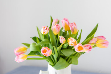 Beautiful spring bouquet of pink tulips close up, flowers in a home interior