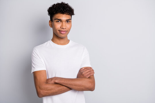 Photo of handsome guy self-assured look camera crossed hands wear white t-shirt isolated grey background