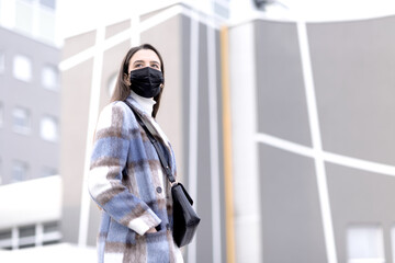 Young fashionable woman wearing a face mask