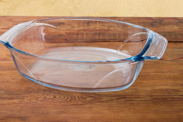 Empty glass casserole pan on an old rustic table