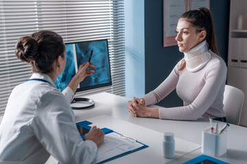 Injured woman with cervical collar in the doctor's office