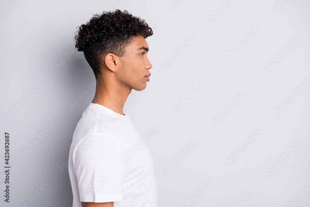 Sticker Profile portrait of brunet optimistic curly guy look empty space wear white t-shirt isolated on grey color background