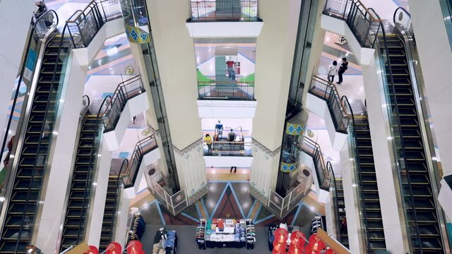 Central Robinson Chiangmai, THAILAND – February 02 2021 ,City's top shopping mall, People or citizens walking up the escalator in a shopping mall, Stock video of small number of people in the mall.