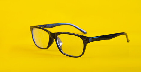 Old and dirty eye glasses  with dust on black frame For reading daily life.