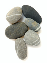 Fototapeta na wymiar Grey pebbles isolated on white background. Grey sea stones with white stripes isolated on white. Studio shot.