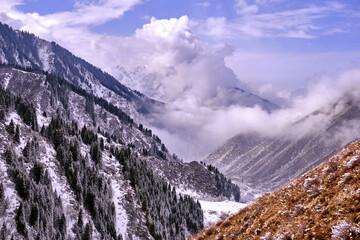 Beautiful mountain valley with clouds in winter season