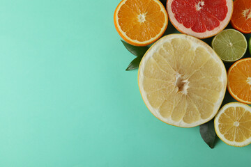 Ripe citrus on mint background, space for text