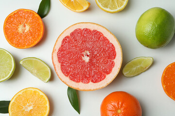 Fresh citrus with leaves on white background, top view