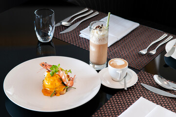 Egg Benedict with prawn and morning drink set ice and hot coffee