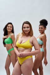 Portrait of confident caucasian woman smiling at camera while posing together with her female...
