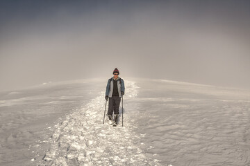 walking hiker in winter mountains