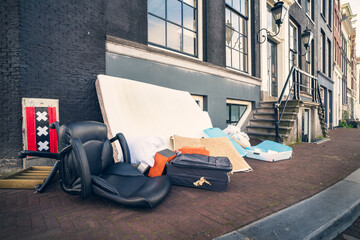 Throwing away unnecessary things that anyone can pick up, old Amsterdam tradition, Netherlands.
