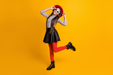 Fototapeta na wymiar Full length body size view of pretty trendy cheerful girl posing dancing having fun touching hat isolated on bright yellow color background