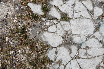 The remains of cracked asphalt on the ground. Top view
