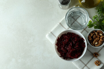 Fototapeta na wymiar Concept of tasty eating with bowl of beet salad on white textured table