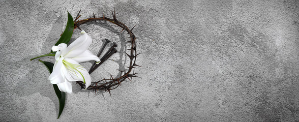Good Friday, Passion of Jesus Christ. Crown of thorns, nails and white lily on grey background....