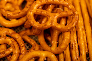 Salted breadsticks and salted pretzels scattered on the table.