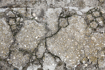 The remains of cracked asphalt on the ground. Top view