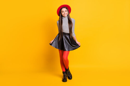 Full length body size view of attractive trendy cheerful long-haired girl wearing funky modern garment isolated over bright yellow color background