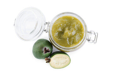Feijoa jam in glass jar and fruits on white background, top view