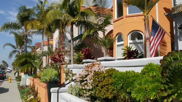 California typical suburban street, tropical Oceanside USA. Different colorful houses row. Generic american homes, buildings facade, townhouse exterior architecture. Residential district real estate.