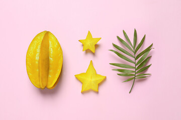 Delicious carambola fruits on pink background, flat lay