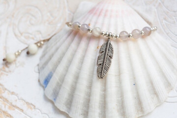 Beautiful mineral stone and metal components necklace on white shell