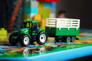 toy model of a tractor with a green trailer
