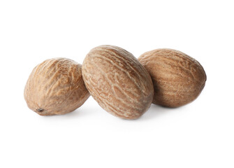 Three whole nutmeg seeds isolated on white