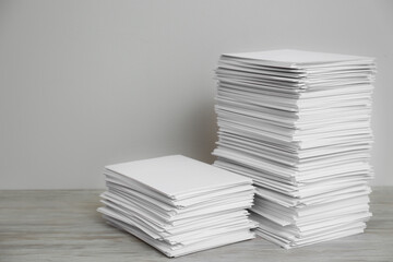 Stacks of paper sheets on wooden table