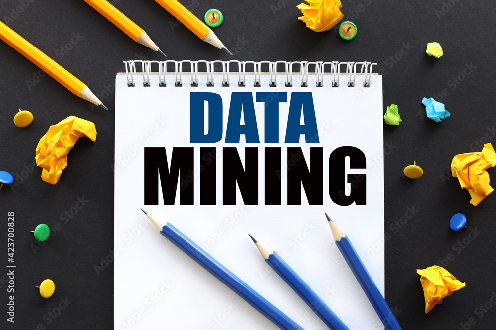 Poster data mining. text on white paper on black background. and multi-colored buttons and crumpled paper