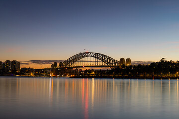 Dawn view of Sydney Harbour Bridge with clear sky.