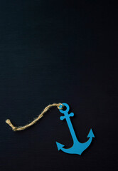 Anchor on a dark background. The concept of sea travel and vacation at sea. Top view, flat lay,...
