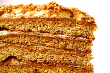 A piece of homemade honey cake with many layers. Closeup