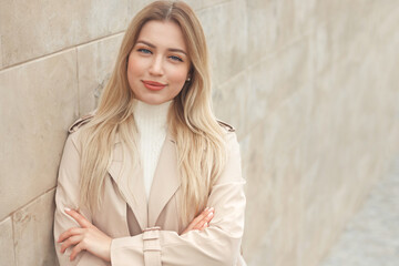 Close up portrait of a beautiful young woman smiling on background of the marble wall