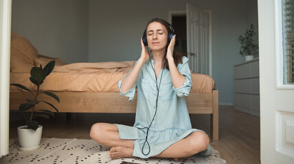 Woman on the floor listening to music with closed eyes