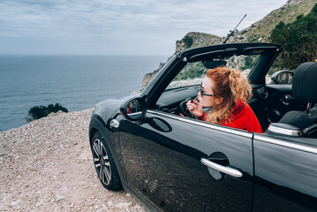 Young woman in cabriolet
