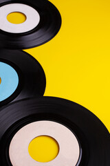 Old Vinyl 45 rpm Records on yellow background