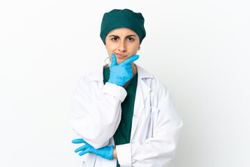 Surgeon caucasian woman isolated on white background thinking