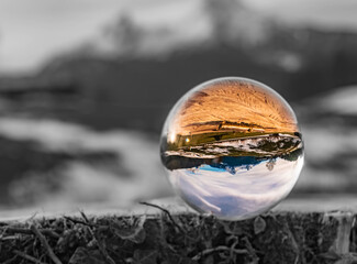 Crystal ball alpine landscape shot with black and white background outside the sphere near Berchtesgaden, Bavaria, Germany