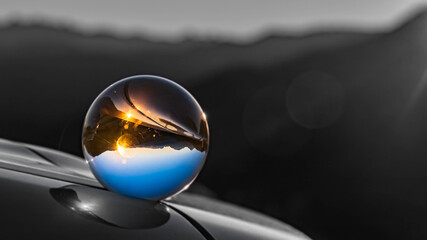 Crystal ball alpine landscape shot with black and white background outside the sphere near Berchtesgaden, Bavaria, Germany